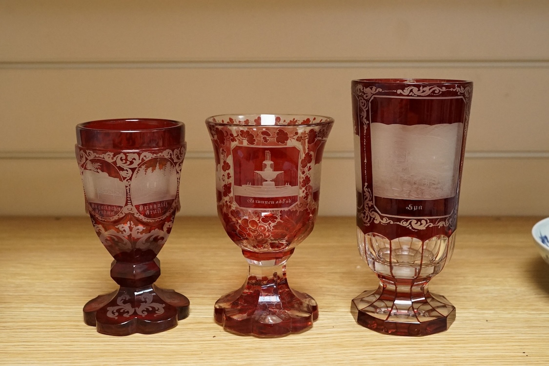 Three Bohemian topographical engraved ruby flashed spa glasses, late 19th century, largest 16cm high